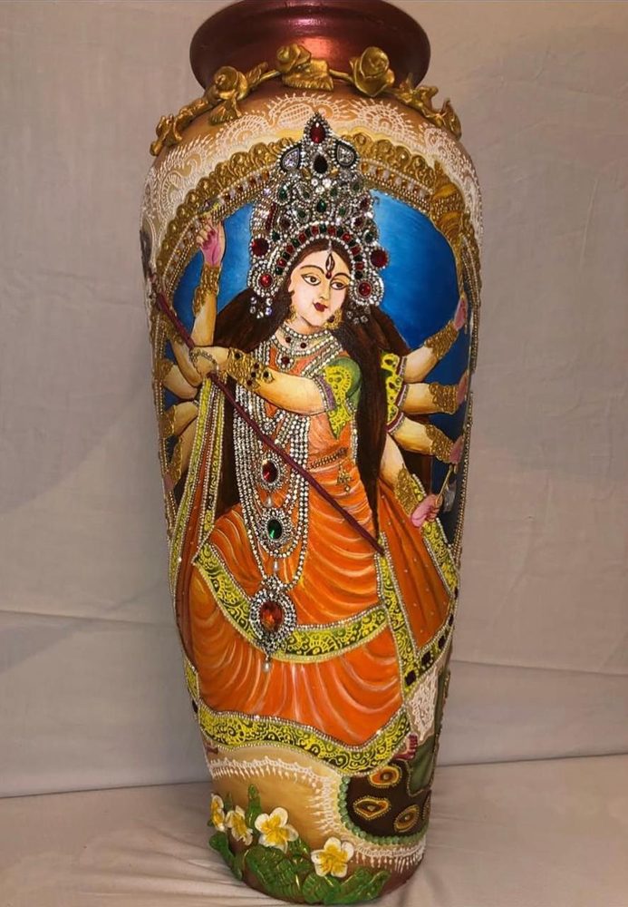 Painting by Anupriya Nagar: Goddess Durga, hand-painted on a terracotta vase with gold relief and stonework